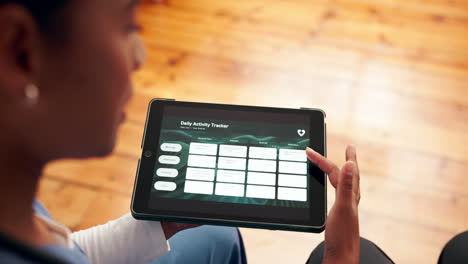 healthcare professional using a daily activity tracker on a tablet