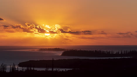 a gloriously golden sunset as seen from n'ga peak on the isle of pines, new caledonia - static time lapse