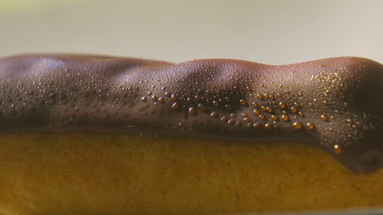 Pan Down to Fresh Eclair Topped with Chocolate and Puff Pastry Filled with Whipped Cream. Traditional French Dessert Ready to Eat and Enjoy. Food Photography.