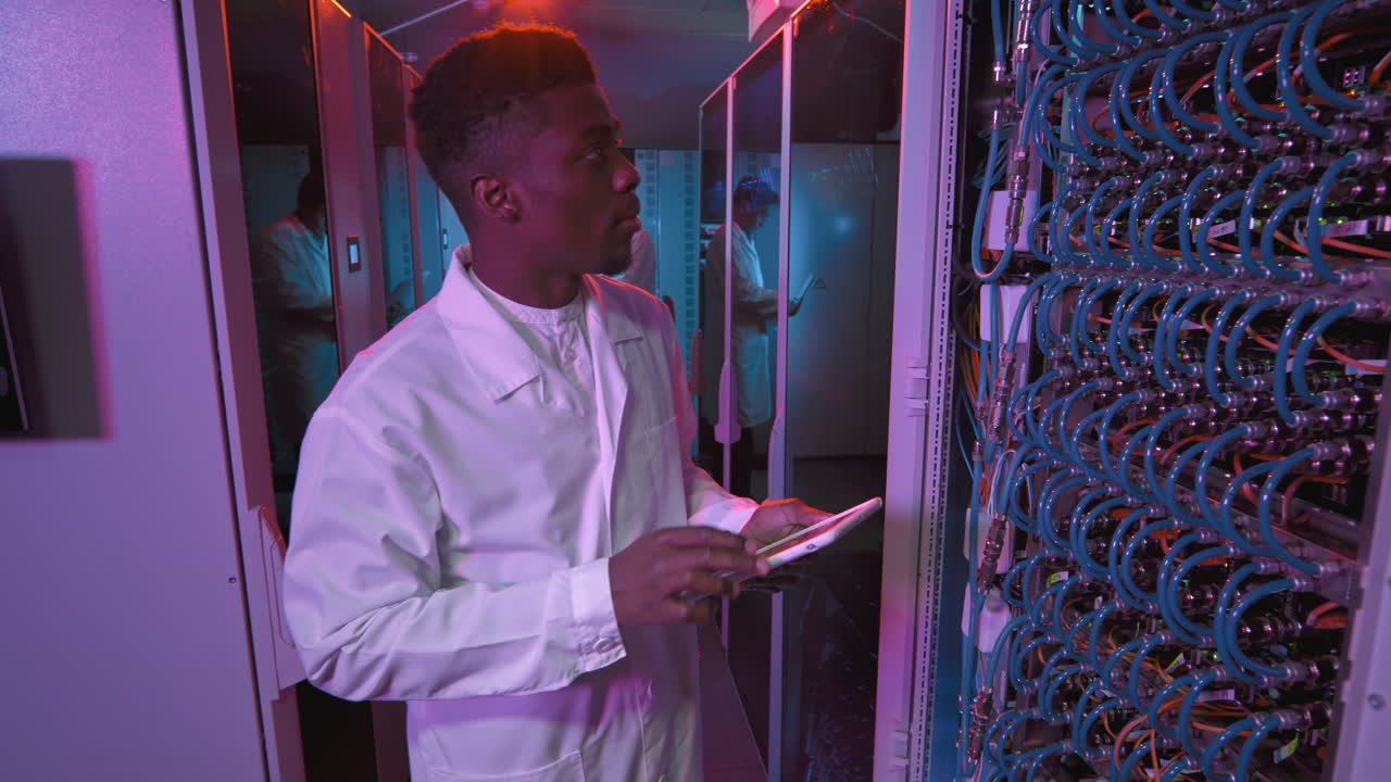 Male IT Specialist Checking Equipment in Data Center