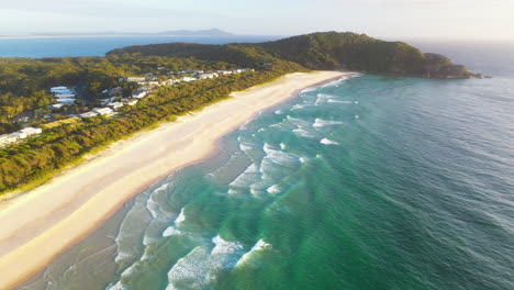 Aerial-shot-of-sunset-over-Pacific-Palms-coastal-houses,-Australia-east-coast