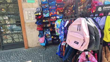 vibrant backpacks displayed outside a naples shop