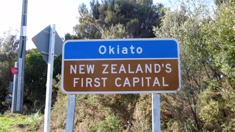 signpost for beautiful, historic, coastal town of okiato, new zealand's first capital, in nz aotearoa