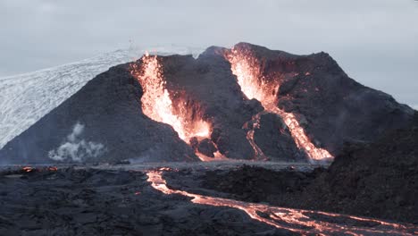 lava spitting volcano in iceland, magma erupting from crater, fagradalsfjall