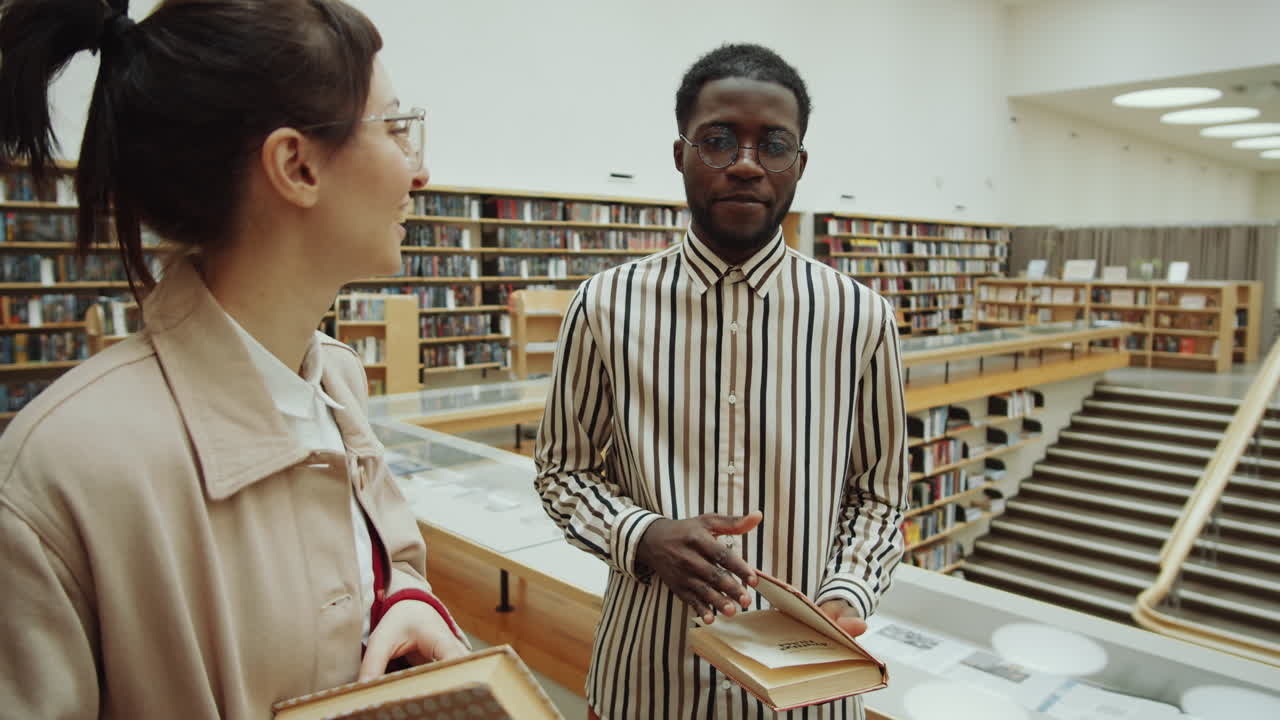 Diverse Friends Discussing Books in Library