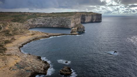 vista aérea de la bahía de dwejra con formaciones costeras dramáticas en un día nublado