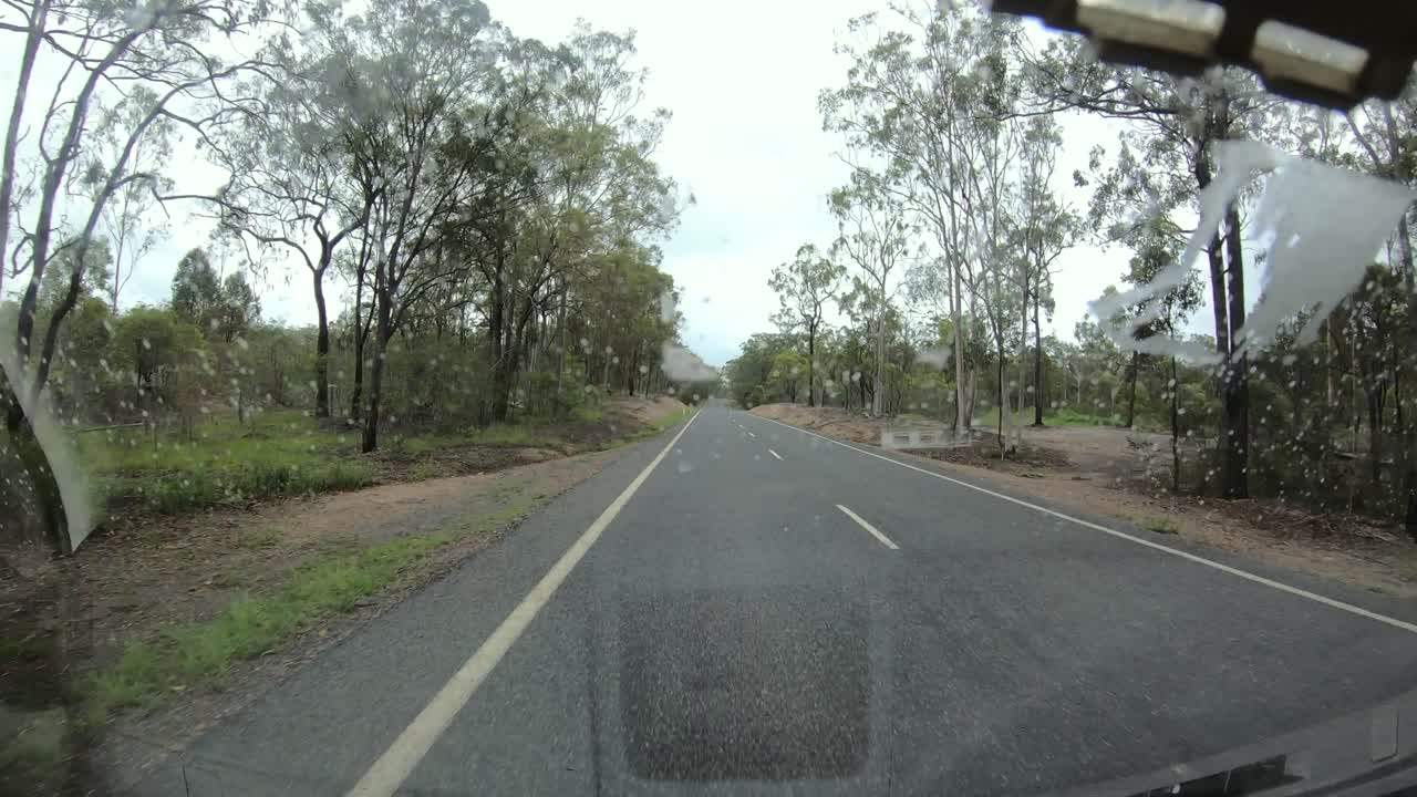 Time lapse of empty road on a cloudy day from window of van. Australian outback