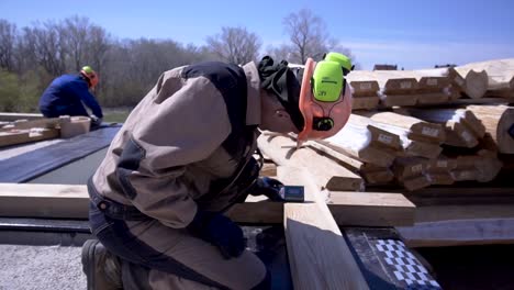 construction workers measuring wooden beams