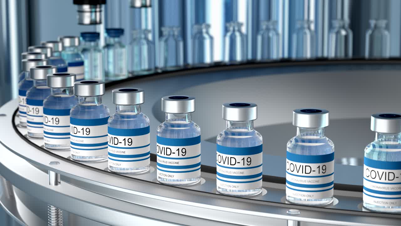 SARS-COV-2 COVID-19 Mass production of coronavirus vaccine, a machine pours the vaccine, seals bottle caps into ampoules moving along a pharmaceutical conveyor belt in a research laboratory