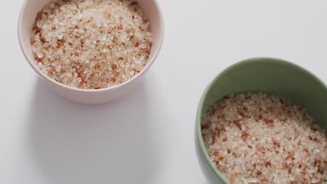 video of himalayan salt in ceramic bowls on white background