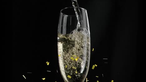 animation of gold confetti falling over glass of champagne on black background