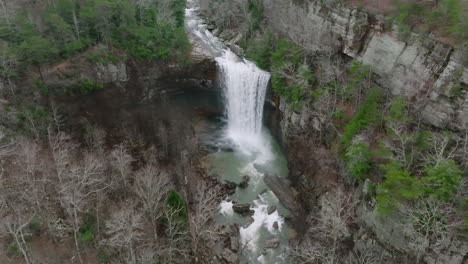 wide aerial shot of waterfall with a pan down at the end