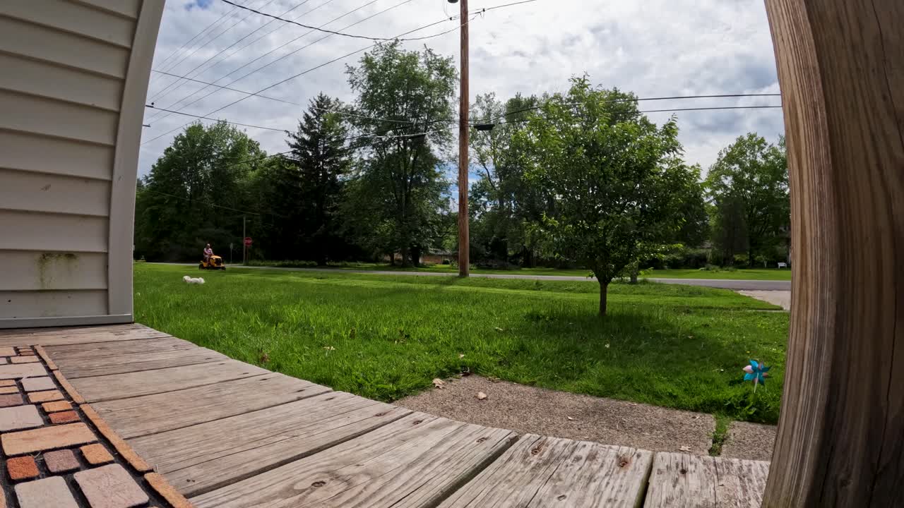 Adult man with lawn mower car tending the lawn