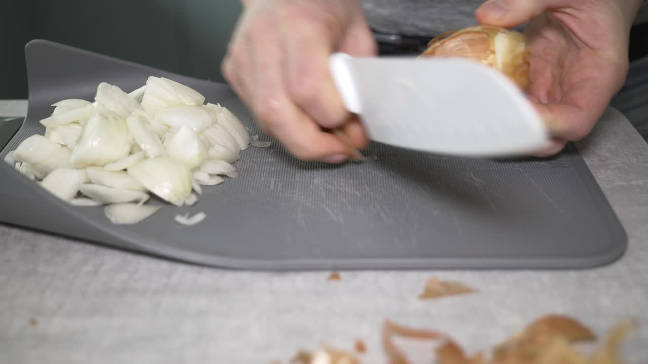 4K footage of a man preparing onions at home