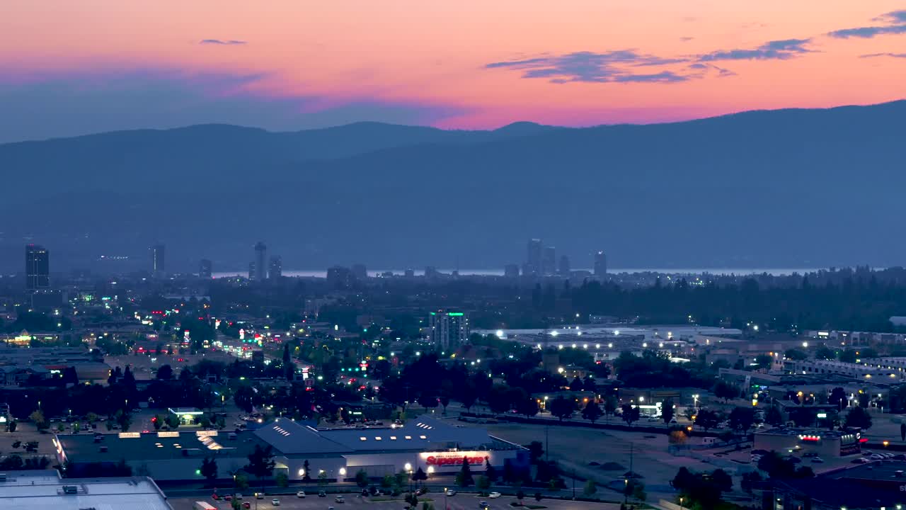 Capture the twilight beauty of Kelowna through drone aerial footage, showcasing the seamless blend of natural landscapes and urban growth in this scenic Canadian city.