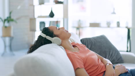 Relax,-music-and-woman-with-headphones-on-sofa