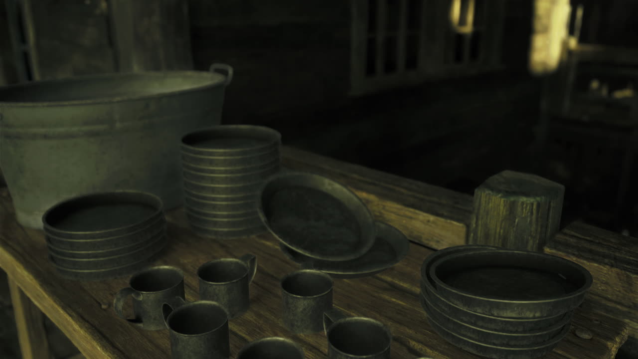 Collection of rustic metal dishes and utensils displayed on a wooden table