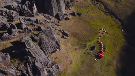 people camping near huge rocks formation, huaraz great cave, peru