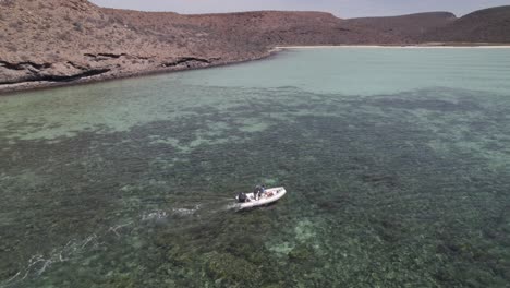 Aerial-drone-shot-of-a-Boat-in-a-colorful-sea