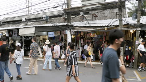 People-walk-the-vibrant-bustle-in-Bangkok's-Chatuchak-Market-with-locals-and-foreigners-shopping-in-Bangkok,-Thailand