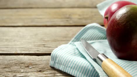 Mango-with-knife-on-wooden-table