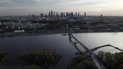 Aerial-panning-view-of-the-Agrafka-bridge-with-the-city-skyline-of-Warsaw-in-the-backdrop