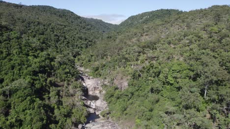 natural pool basin surrounded by dense rainforest landscape