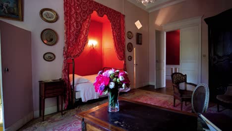 slow revealing shot of an antique-decorated bedroom within a chateau in france