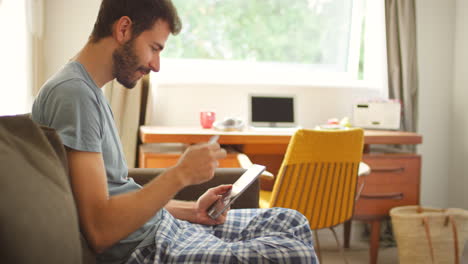 A-young-man-making-a-card-payment-using