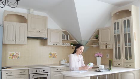 A woman working at home in her kitchen
