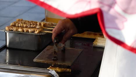 sequential preparation of roast pork by a vendor