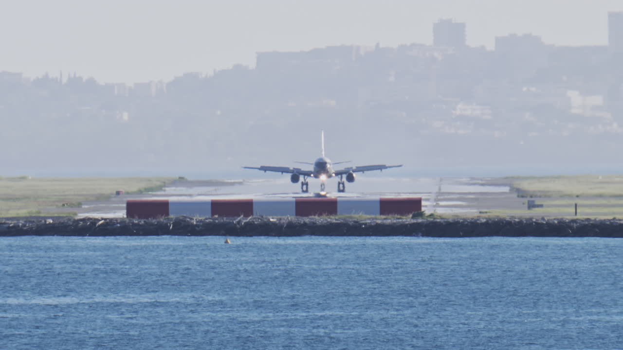 Distant view of airplanes landing at the Nice Cote d'Azur Airport in daylight