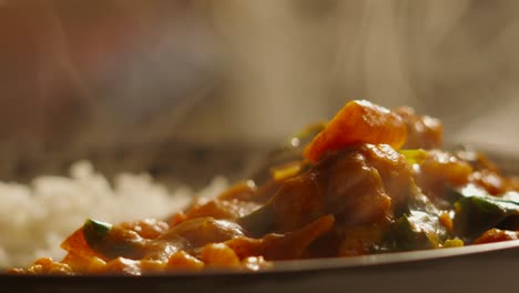 Slow-Motion-Steam-Rising-from-Freshly-Cooked-Indian-Cuisine-Vegetable-Tikka-Masala-Curry-with-Cauliflower,-Spinach,-Peppers---4K-High-Quality-Footage