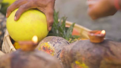 indian man setting up fruits for god