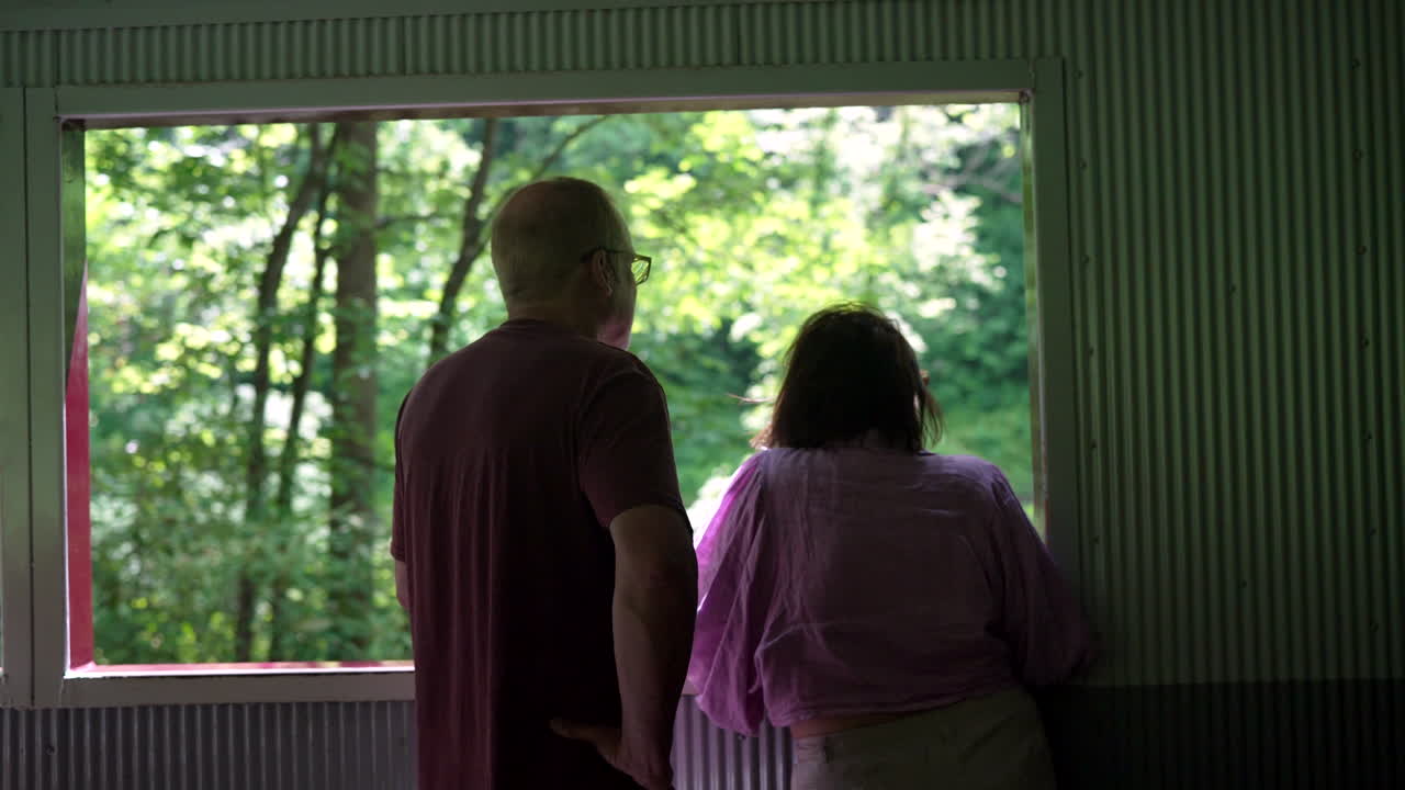 Older couple enjoying a scenic train ride in the forest, nature, retirement, parents, tourist, travel, scenic, journey