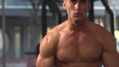 fit muscular man posing and looking to the camera