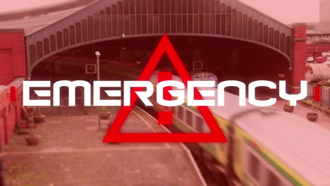 word emergency written over triangle warning road sign over train passing in the background.