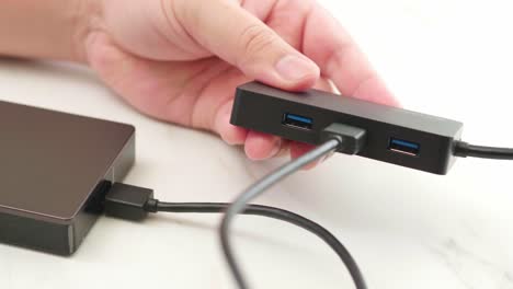 man connect cable usb of the external hard disk to the hub for backup and transfer digital data