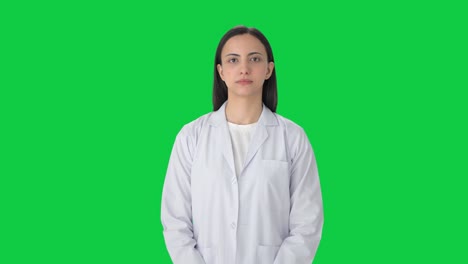 Serious-Indian-female-scientist-looking-Green-screen