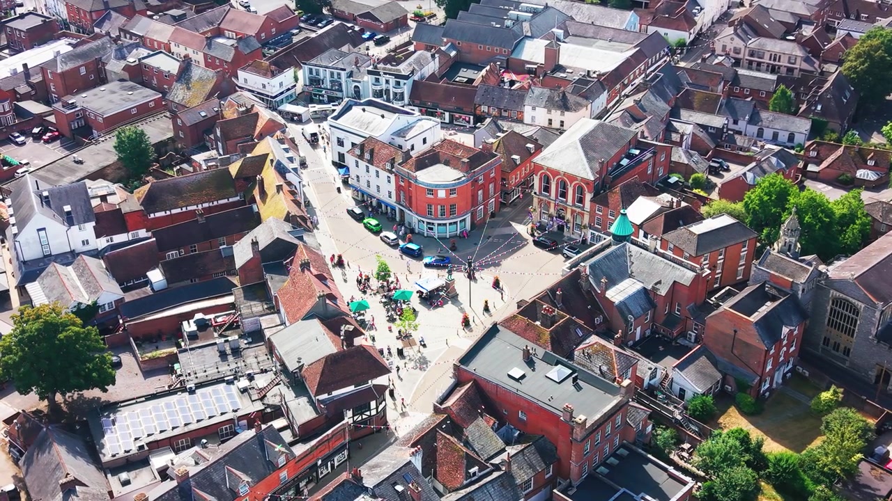 Droneopptak over Romseys historiske markedsplass, handlegater og rådhus, med klosteret i nærheten.