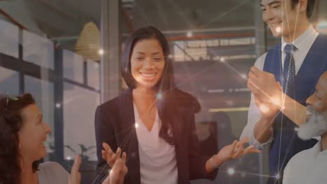 animation of network of connections over diverse businesspeople clapping for biracial businesswoman