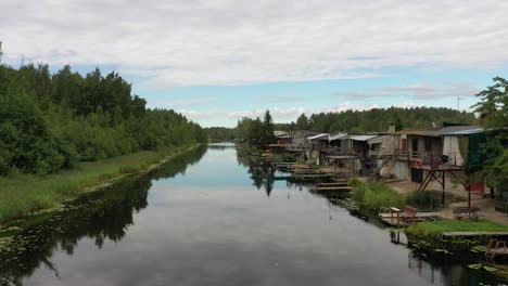close drone video of village of illegal self-made garage-houses next to the lake