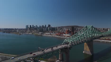 aerial view of traffic car driving on the jacques cartier bridge cantilever bridge crossing the saint lawrence river from montreal island,quebec canada