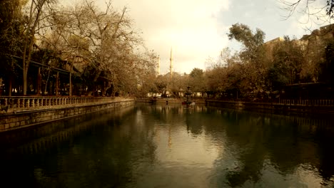 lake ayn-zelih clouds float across sky reflected wuntry warm day urfa