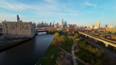 aerial drone footage of the chicago chinatown cityscape with river, bridge, and skyscrapers during golden hour