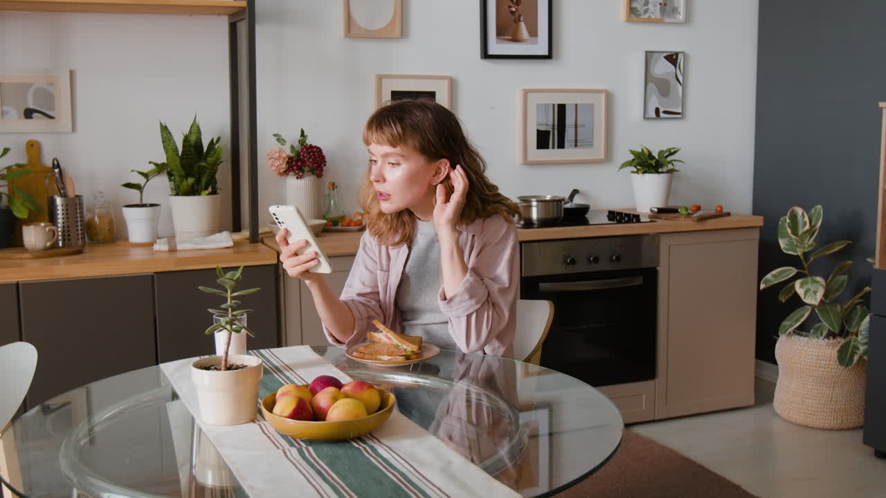 Woman using phone at the table