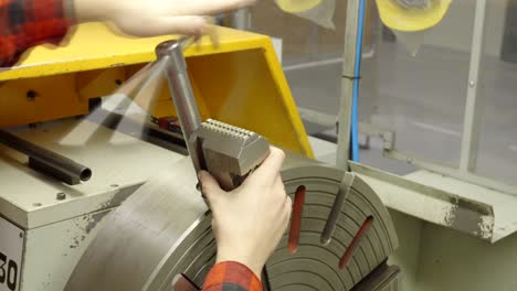 metal lathe, worker disassembles the chuck