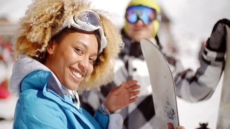 Close-up-of-skier-holding-snowboard