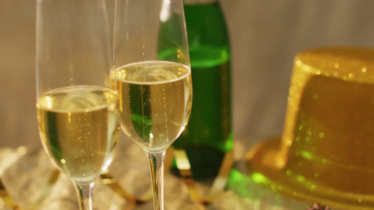 Champagne glasses and decorations on green background at new year's eve