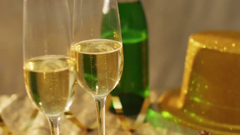 Champagne-glasses-and-decorations-on-green-background-at-new-year's-eve
